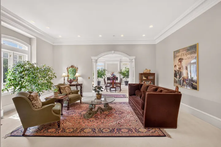 Formal sitting room with a patterned rug and traditional furnishings