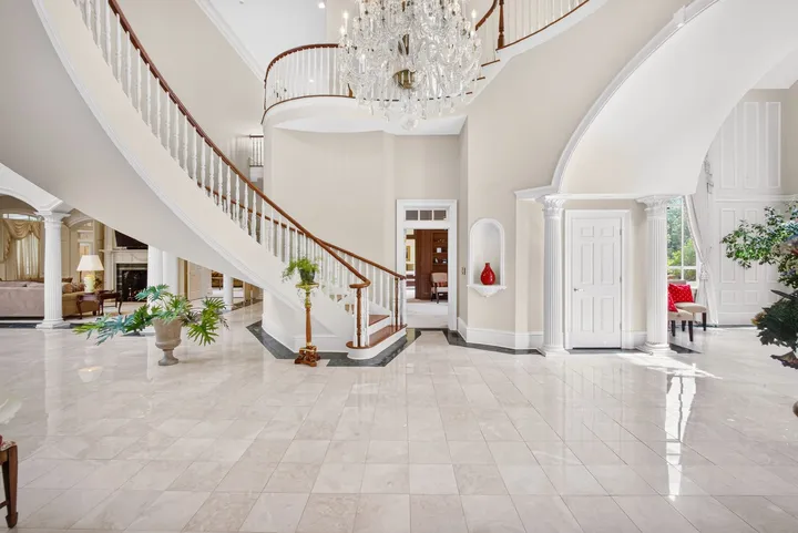 Marble foyer at the foot of the curved staircase
