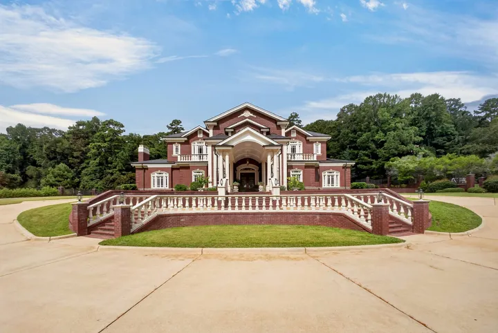 Front elevation and balustraded entry stair across the circular drive