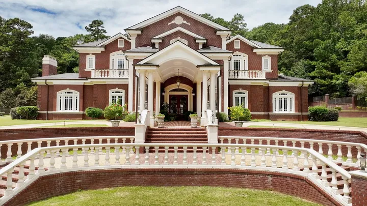 Front elevation with a columned portico and balustraded terrace