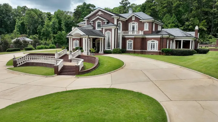 Aerial view of the brick residence and its curved entry stairs
