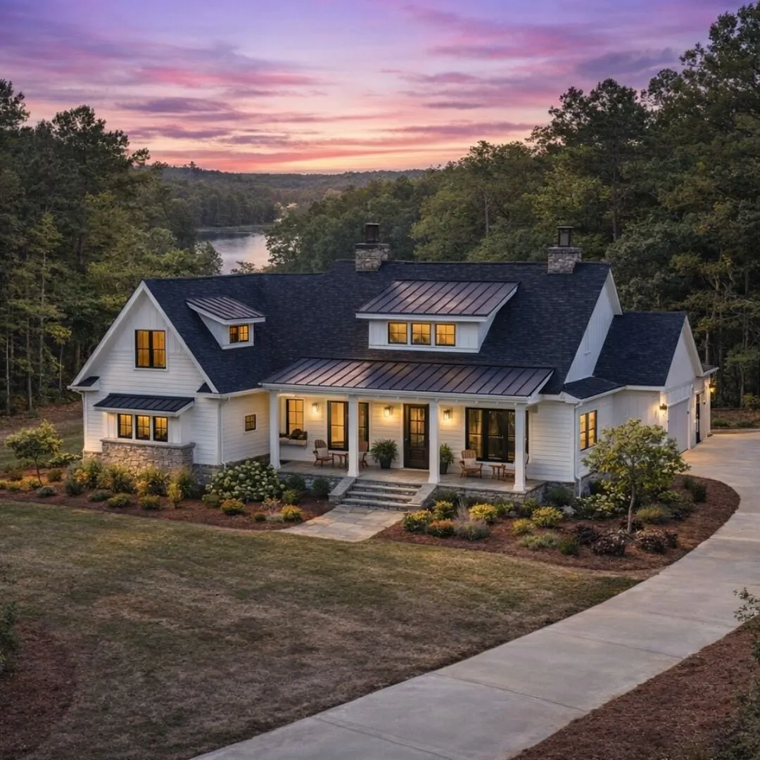 A custom home at twilight beside a lake